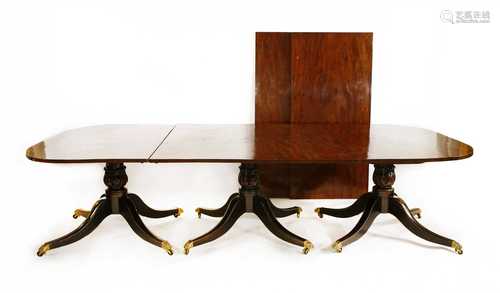 A George III-style mahogany triple pillar dining table,