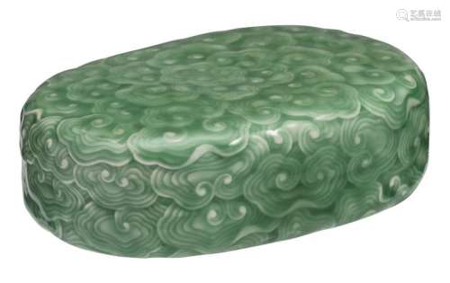 A celadon glazed object, allover decorated with incised