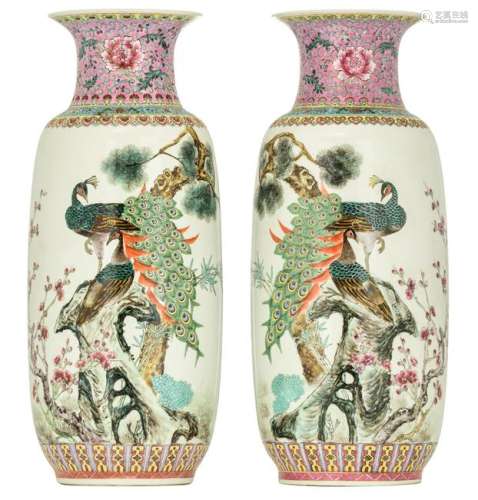 A pair of Chinese famille rose vases, decorated with