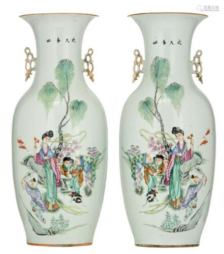 A pair of Chinese famille rose vases, decorated with