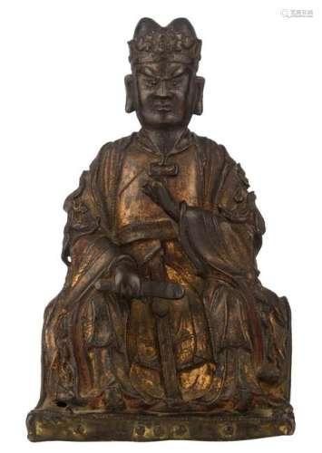 A Chinese patinated bronze figure depicting a seated