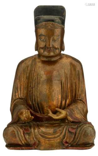 A gilt and lacquered wooden figure depicting a seated