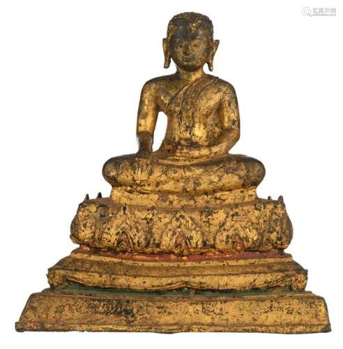 An Oriental gilt bronze seated Varada mudra Buddha on a