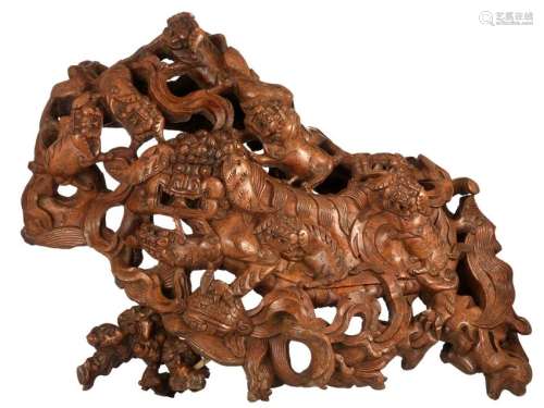 A Chinese burl wood sculpture depicting playing kylins,