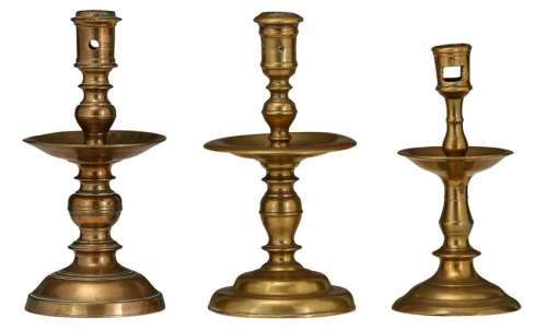 A lot of three bronze candlesticks of the Heemskerk