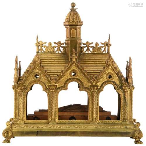 A gilt brass Gothic Revival shrine with a wooden figure