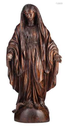 An oak sculpture of the Holy Mother crushing the head