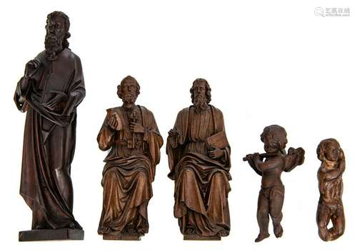 A pair of oak sculptures depicting a seated Saint Peter