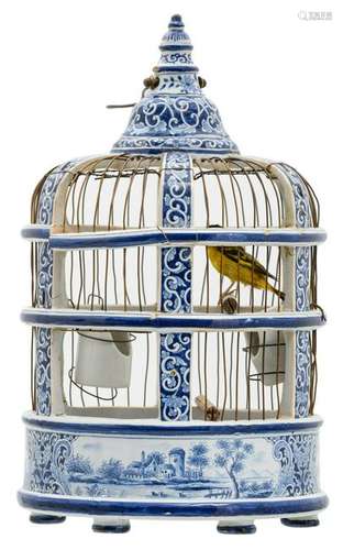 A 19thC Dutch blue and white birdcage with a stuffed