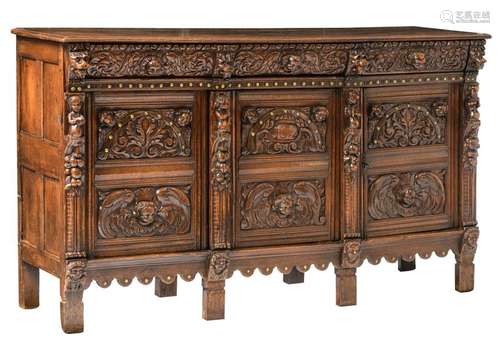 A 17thC oak cupboard, richly decorated with brass nails