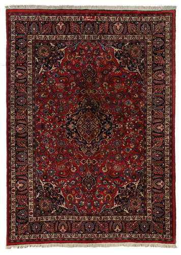 An Oriental floral decorated woollen rug with central