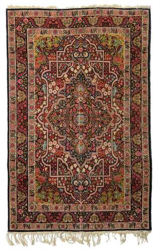 An Oriental woollen rug, decorated with floral motifs