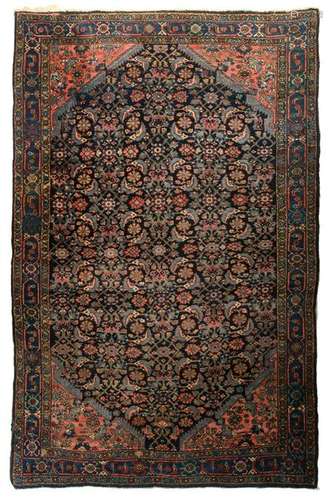 An Oriental woollen rug, decorated with floral motifs,