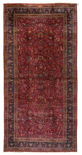 A large Oriental woollen rug, decorated with flowers