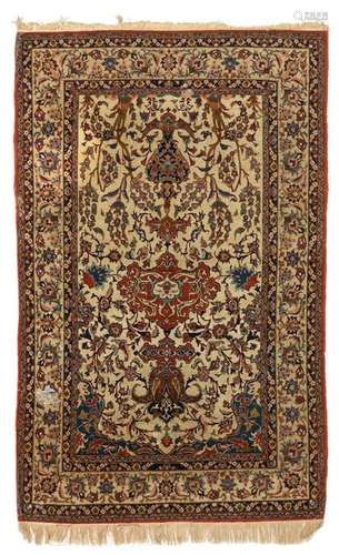 An Oriental woollen rug, decorated with floral motifs,