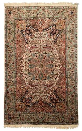 An Oriental woollen rug, decorated with floral motifs