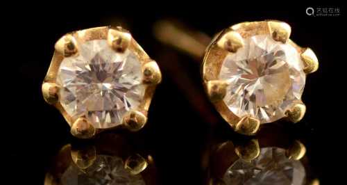 A pair of diamond stud earrings