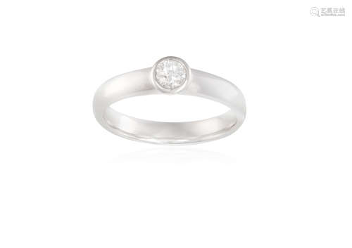 A DIAMOND SINGLE-STONE RING, the round brilliant-cut diamond within collet-setting, to a plain 18K