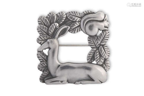 A SILVER BROOCH BY GEORG JENSEN, the recumbent deer to a square freme of leaves with a squirrel to
