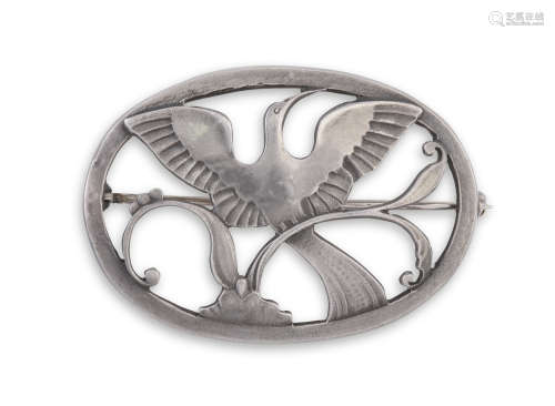 A SILVER BROOCH BY GEORG JENSEN, the oval-shaped frame enclosing a stylised bird in flight, with