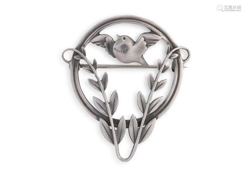 A SILVER BROOCH BY GEORG JENSEN, the circular frame enclosing a small bird in flight above a