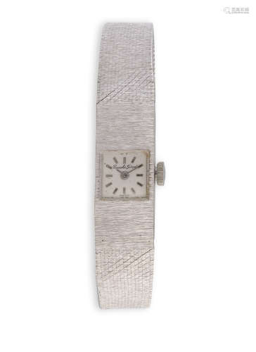 A LADY'S GOLD WATCH BY BUECHE GIROD CIRCA 1960, the signed square dial with baton markers, to a