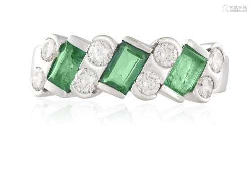AN EMERALD AND DIAMOND DRESS RING, composed of rectangular step-cut emeralds, each interspersed with