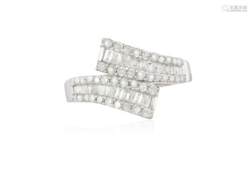 A DIAMOND CROSS OVER RING, composed of baguette-cut diamonds within a frame of brilliant-cut