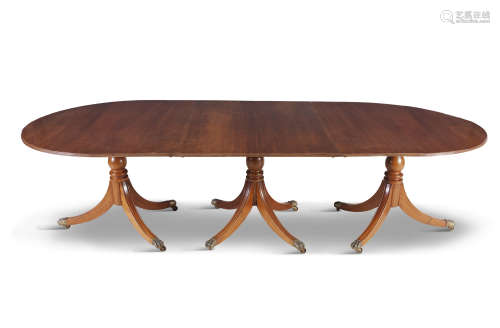 A GEORGIAN STYLE MAHOGANY D-END TRIPLE PILLAR DINING TABLE, with reeded rim raised on baluster