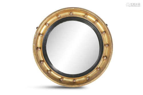 A 19TH CENTURY GILTWOOD CONVEX MIRROR, the circular plate enclosed by reeded ebon slip, within the