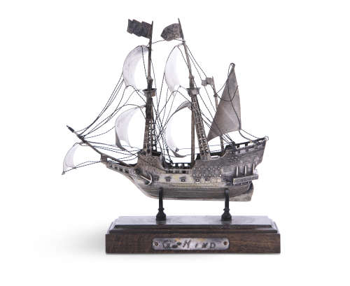 A VENETIAN WHITE METAL MODEL OF A SCHOONER, mounted on a timber plinth; together with a smaller