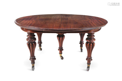 A FINE VICTORIAN MAHOGANY CIRCULAR EXTENDING DINING TABLE, the moulded rim raised on baluster turned
