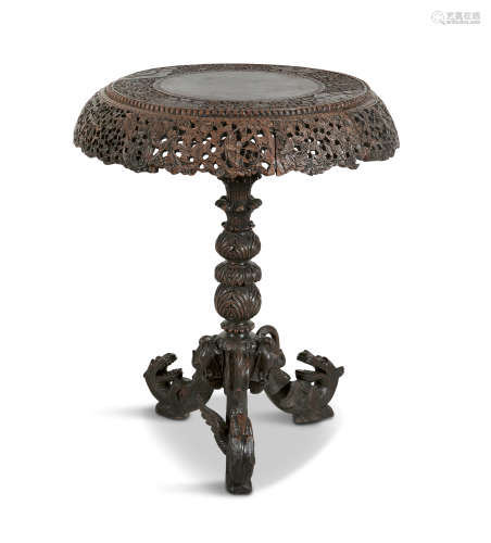 AN ANGLO INDIAN EBON TILT-TOP CENTRE TABLE, C.1900, of shaped circular form, the plain reserve