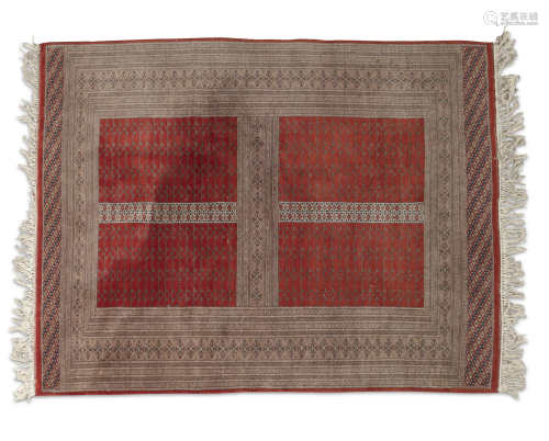 A CAUCASIAN RED AND CREAM GROUND RUG, of oblong shape, the compartmented field divided into four