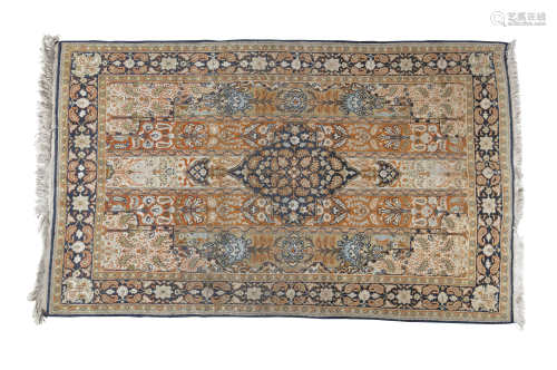 A PERSIAN ORANGE GROUND WOOL RUG, 20th century, the centre field woven with five vertical panels and