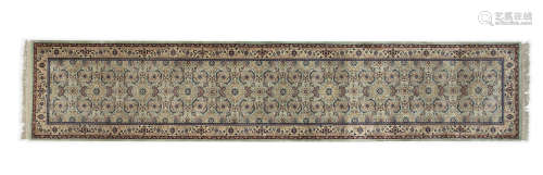 A PISTACHIO GREEN GROUND WOOL RUNNER, the oblong field woven with a repeated geometric motifs. 372 x