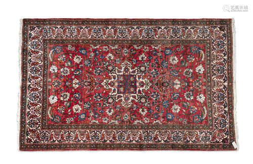 A PAIR OF EASTERN RED GROUND WOOL RUGS, 20th century, of rectangular form, the large field centred