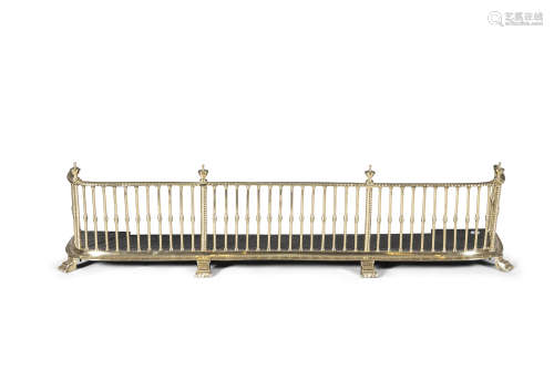 A TALL GEORGE III STYLE BRASS FENDER, 19th Century, the rope twist top rail surmounted by urn