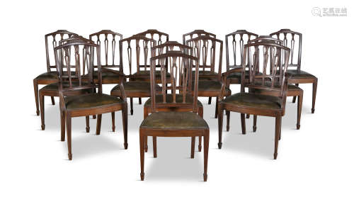 A SET OF 14 MAHOGANY FRAMED DINING CHAIRS, of Shearton design, comprising two carvers and twelve