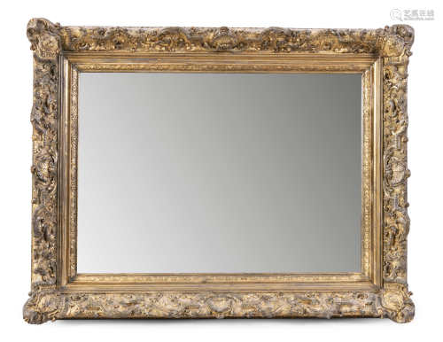 A FINE 19TH CENTURY GILTWOOD AND GESSO PICTURE FRAME, fitted with bevelled mirror plate, with