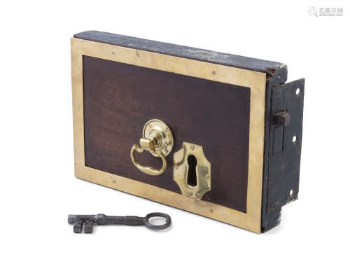 A GEORGIAN MAHOGANY AND BRASS MOUNTED DOOR LOCK, of rectangular shape with brass bracket handle,