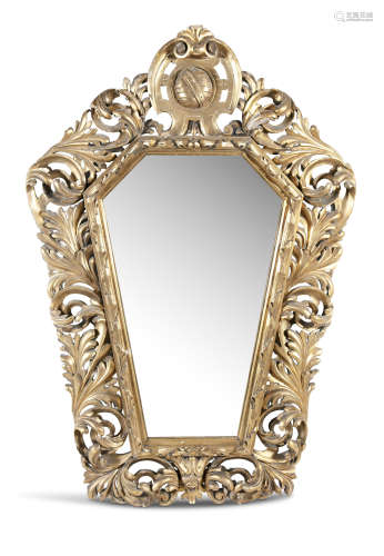 A LARGE 19TH CENTURY GILTWOOD SHIELD SHAPED MIRROR, the frame carved with continuous leaf scrolls