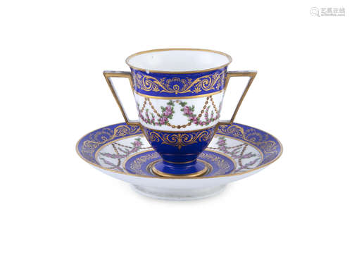 A SEVRE PORCELAIN HANDPAINTED CUP AND SAUCER, paint blue and parcel gilt with floral swag