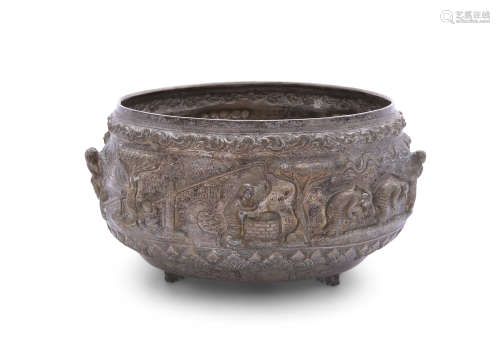 A LARGE THAI WHITE METAL BOWL OF CIRCULAR FORM, chased and embossed with a continuous domestic trade