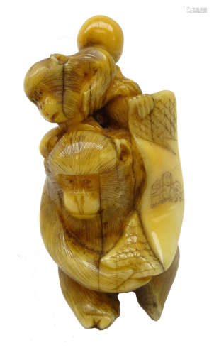 Japanese Meiji ivory Okimono carved as two Monkeys holding a banner, H6.