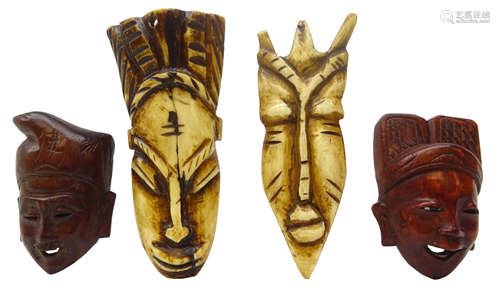 Two 19th/ early 20th century African carved bone face masks,