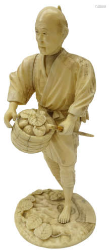 Japanese Meiji period carved ivory figure of a Farmer dressed in a robe, holding a basket and stick,