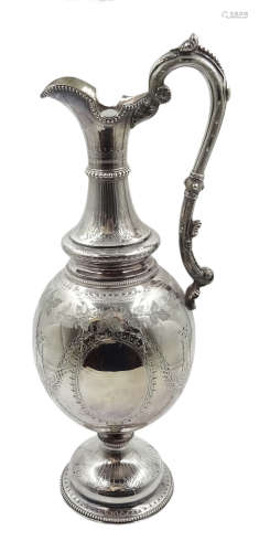 Victorian silver claret jug, ovoid form body chased with floral garlands,