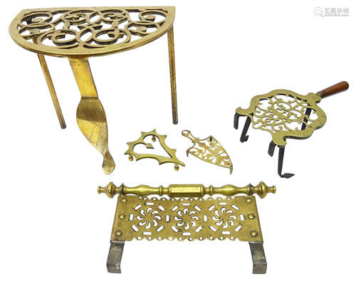 Early 19th century pierced brass trivet raised on three legs, H31cm,