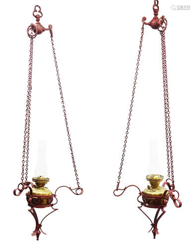 Pair painted cast iron hanging oil lanterns, openwork frame, chain fitting with brass oil lamps,